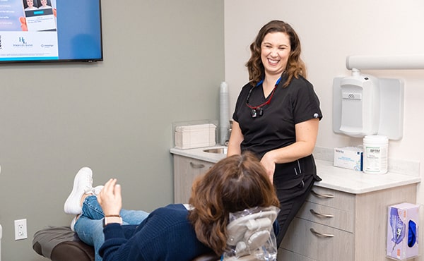 Dr. Kristy in the dental office talking to the patient about Xerostomia treatment