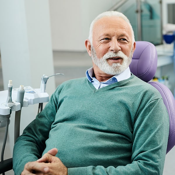 A mature man at the dentist waiting for his smile checkup