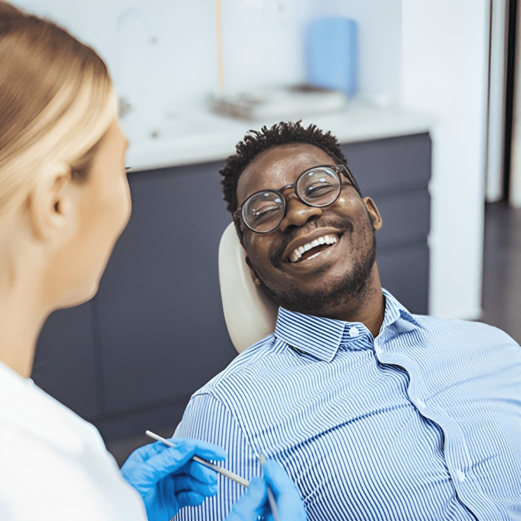 A man at the dentist smiling while waiting for his consultation